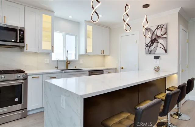 a kitchen with a sink cabinets and stainless steel appliances