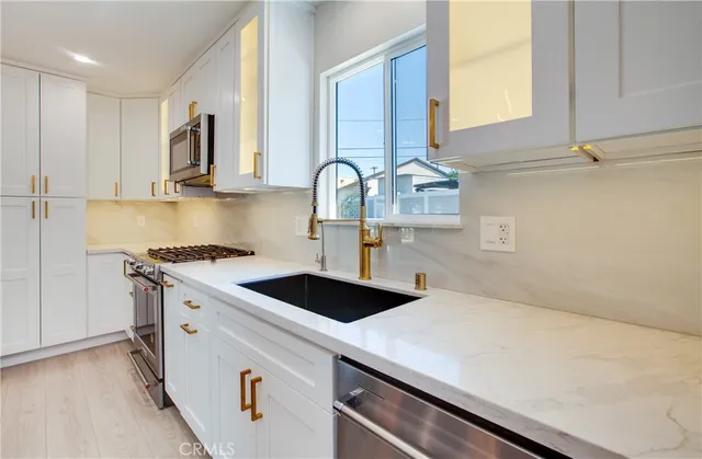 a kitchen with a sink and cabinets