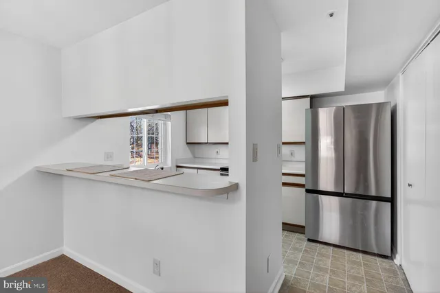 a kitchen with stainless steel appliances a refrigerator and cabinets