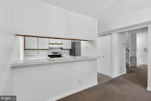 a kitchen with a sink and a refrigerator