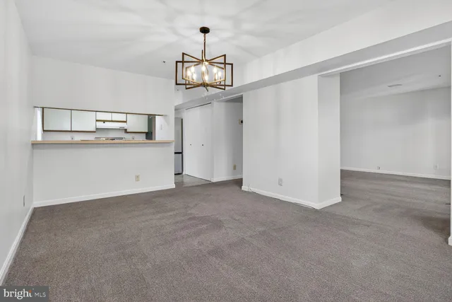 a view of a hallway with a kitchen
