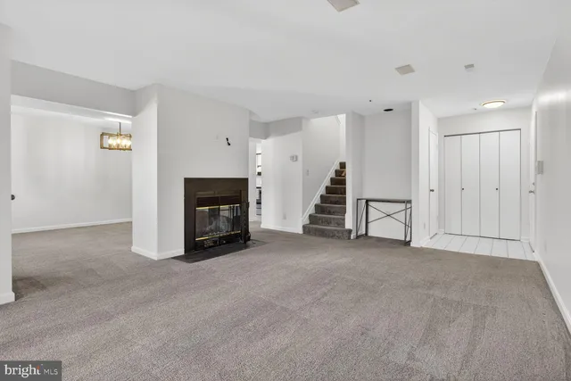a view of an empty room with fireplace