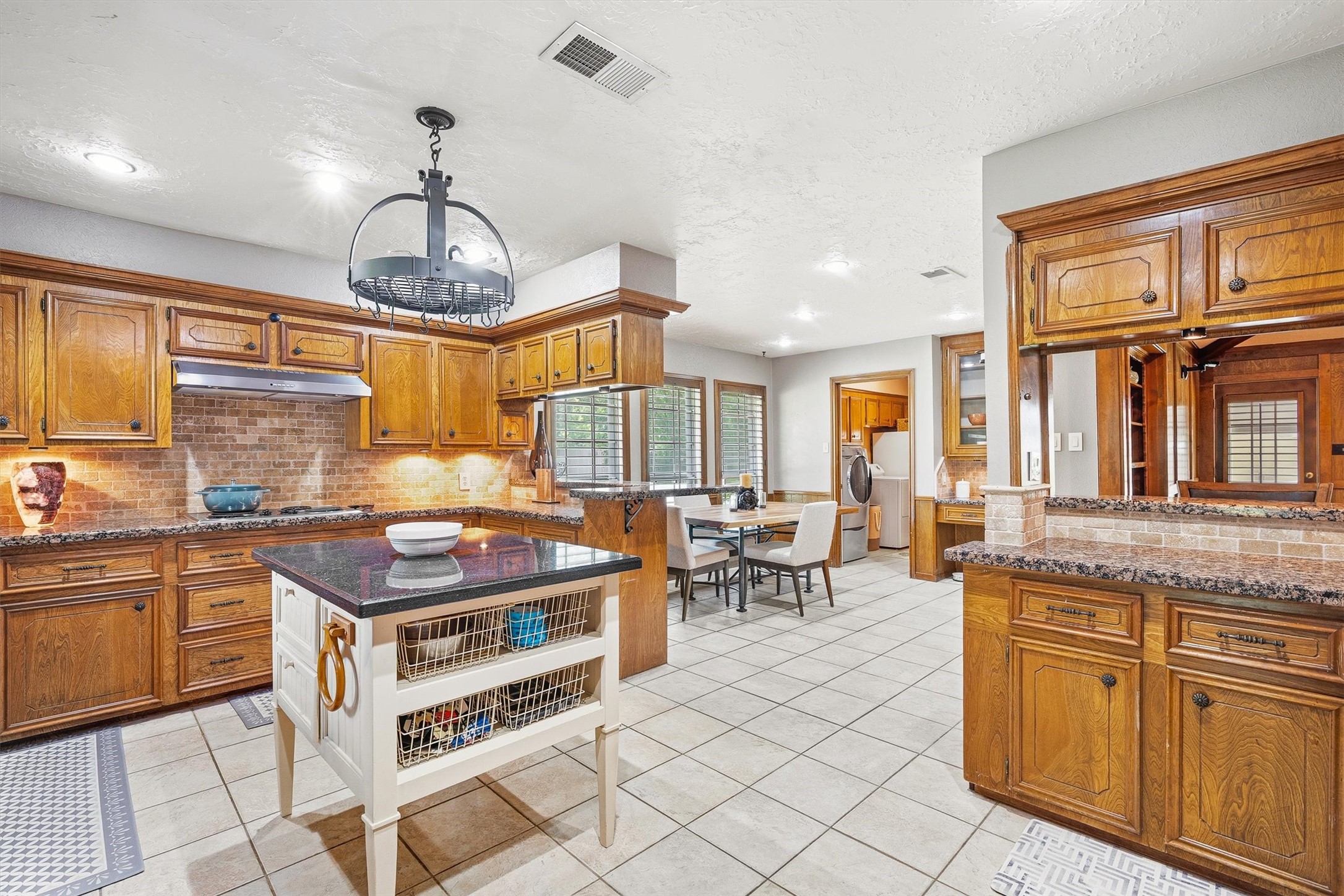 826 North Rivershire Drive Conroe, TX 77304 - Photo 15 of 46 Island, breakfast area, built-in desk, wet bar. This kitchen has more going on than most homes twice the size.