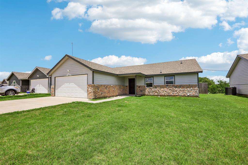 a front view of a house with a yard and garage