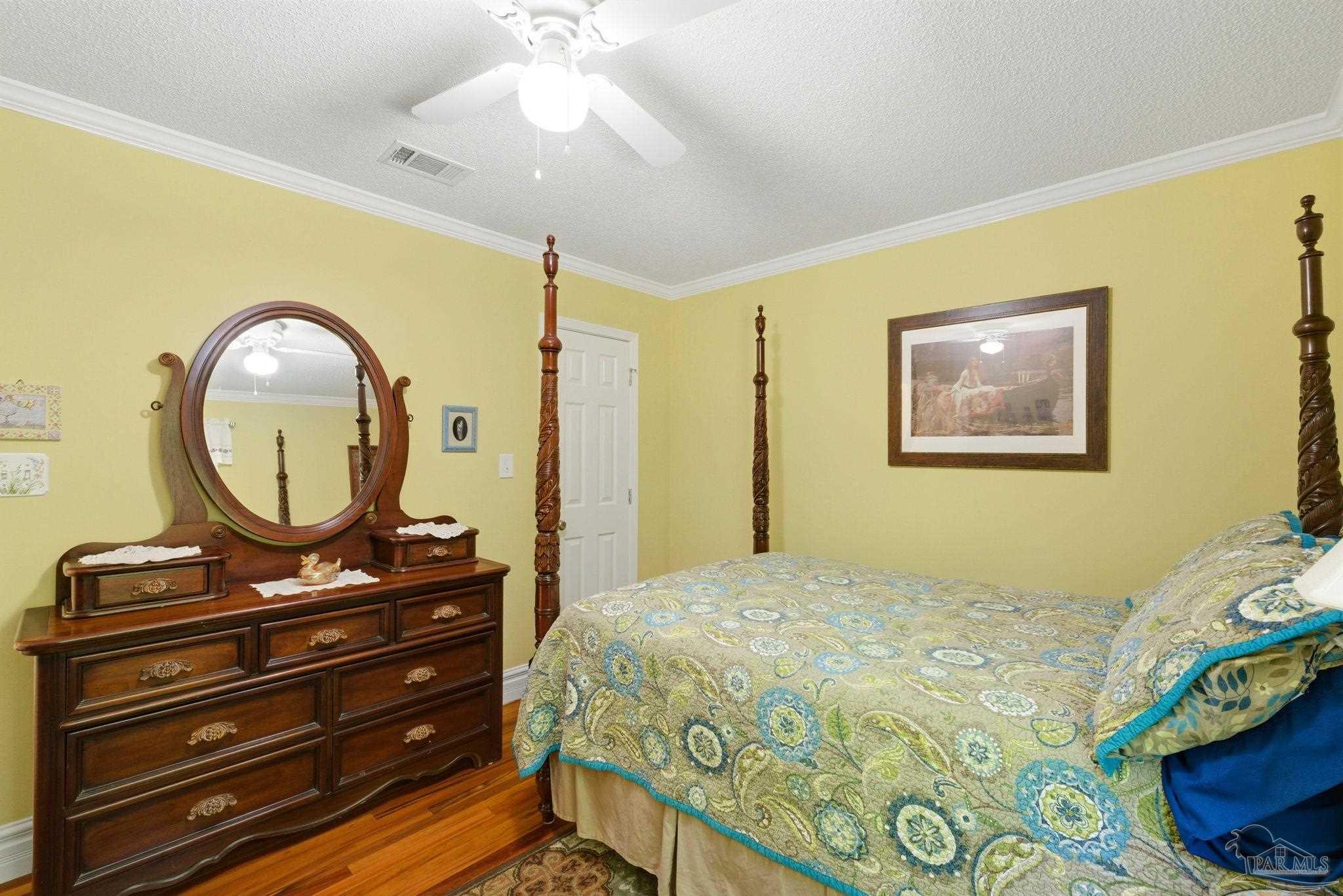 6930 Summit Way Milton, FL 32570 - Photo 37 of 71 a bedroom with a bed and a mirror