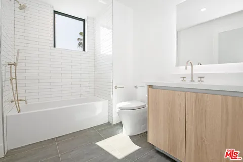 a bathroom with a toilet a sink and bathtub