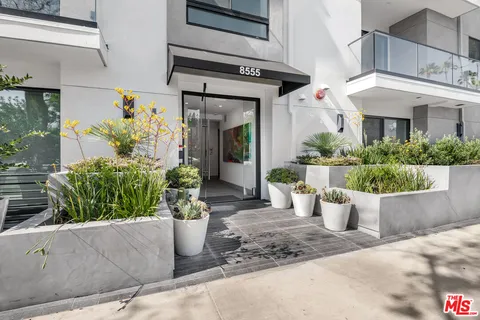 a view of a house with potted plants