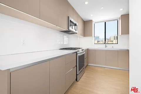 a kitchen with a sink stove and cabinets