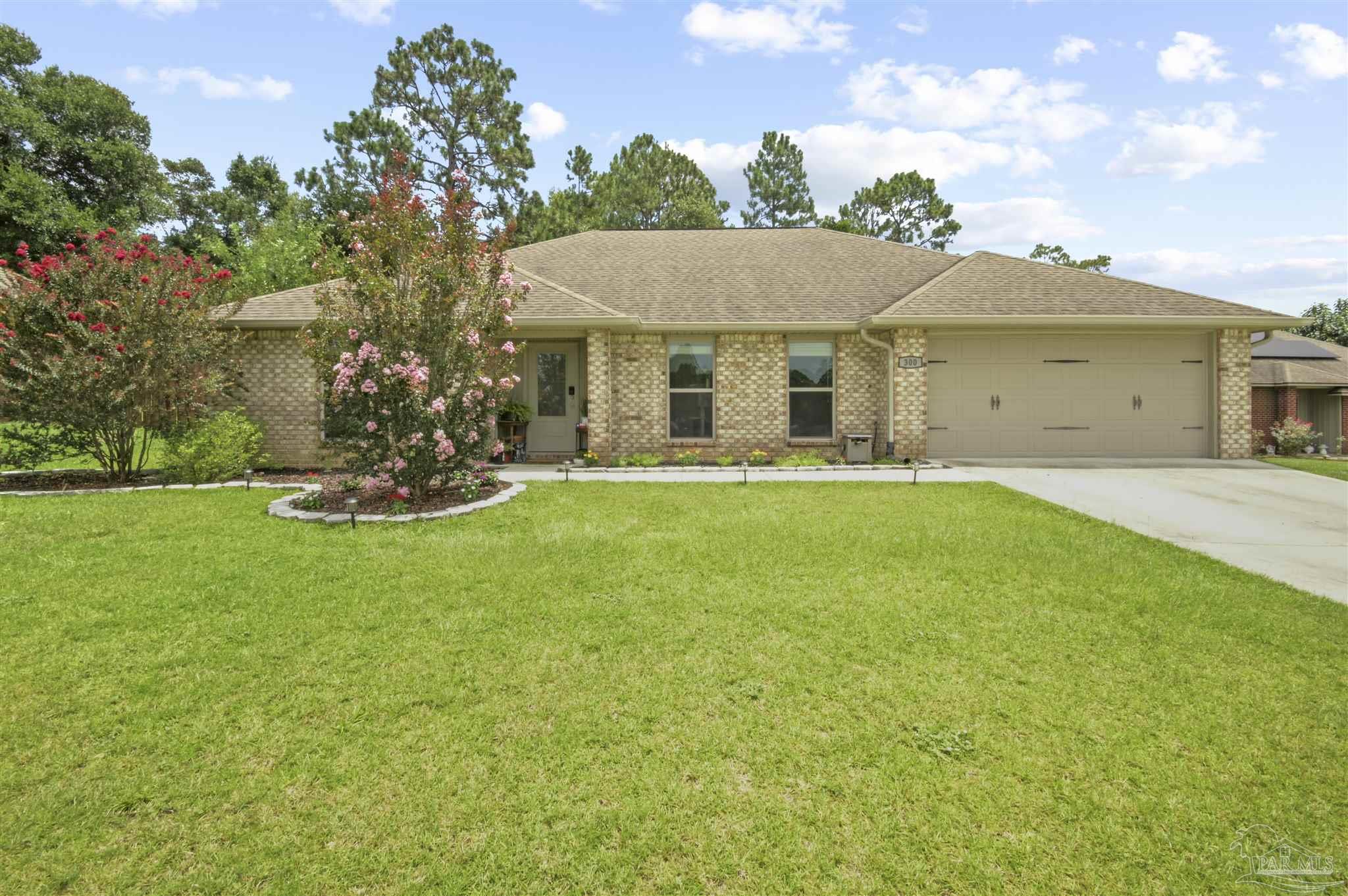 300 Cassady Lane Crestview, FL 32539 - Photo 1 of 25 a front view of a house with a garden and yard