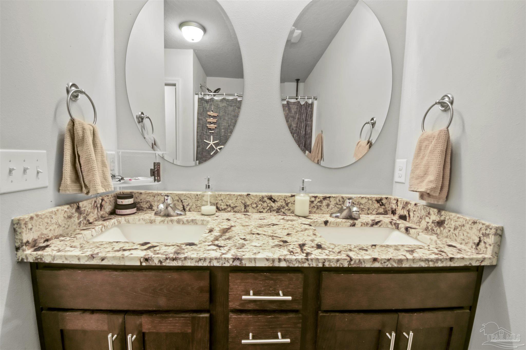 300 Cassady Lane Crestview, FL 32539 - Photo 16 of 25 a bathroom with a granite countertop sink and a mirror
