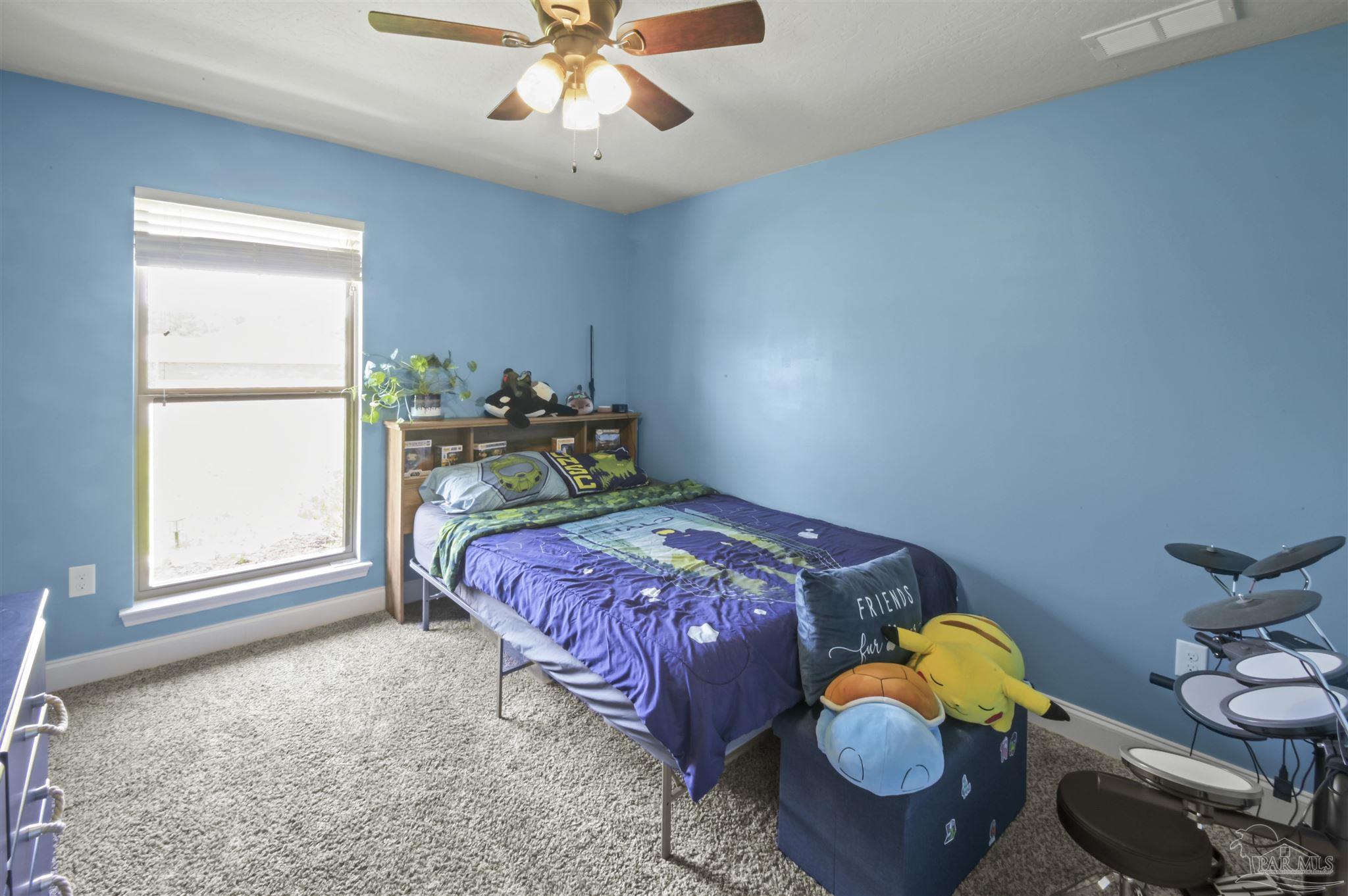 300 Cassady Lane Crestview, FL 32539 - Photo 19 of 25 a bedroom with a bed and wooden floor