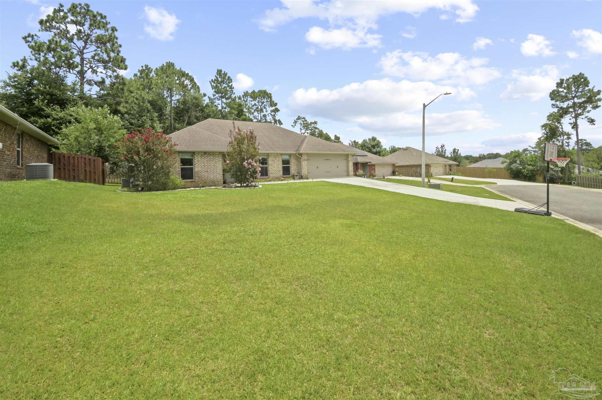 300 Cassady Lane Crestview, FL 32539 - Photo 2 of 25 a view of a large garden with plants and large trees