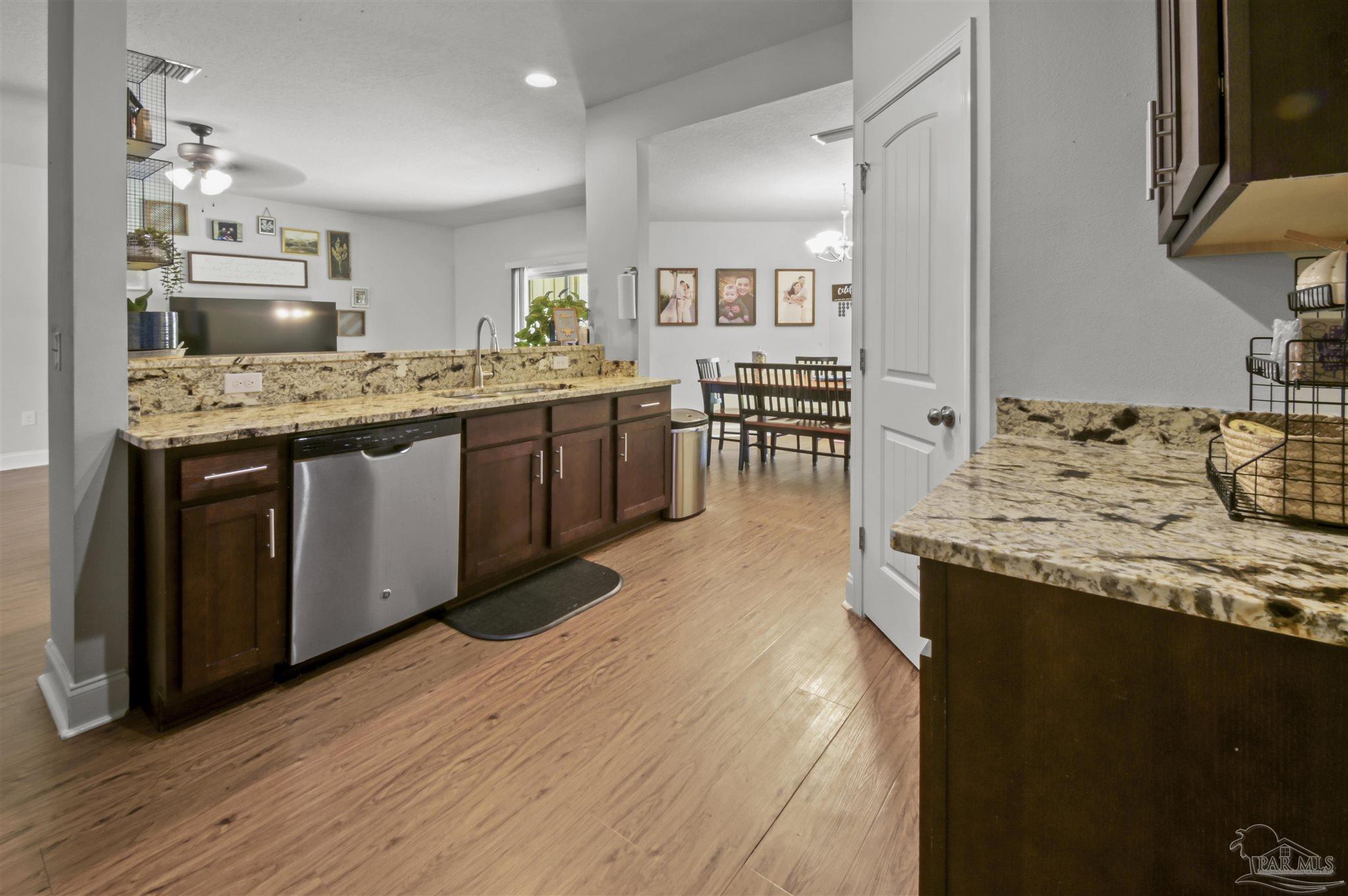 300 Cassady Lane Crestview, FL 32539 - Photo 10 of 25 a kitchen with stainless steel appliances granite countertop a sink stove and refrigerator