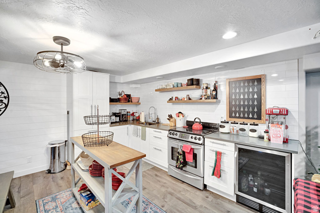 2139 Village Point Way Sandy, UT 84093 - Photo 23 of 35 Light wood-finish flooring complements white shiplap wall accents and white cabinetry.