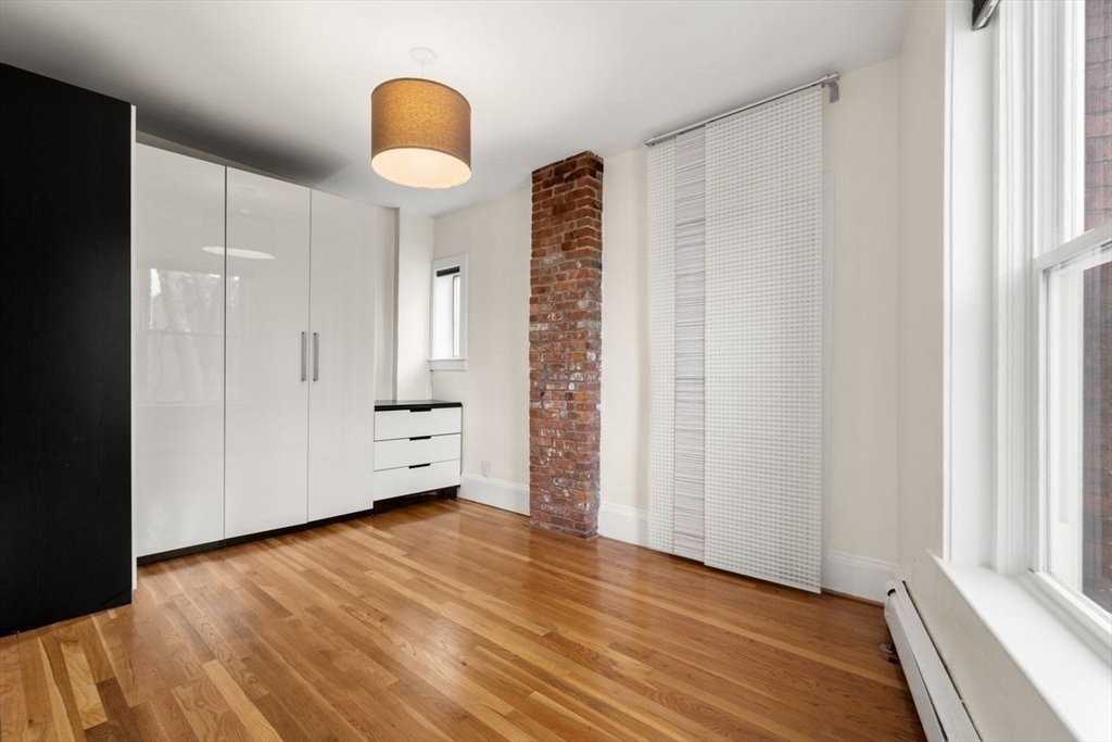 96 Brook Street, Unit 3 Brookline, MA 02445 - Photo 12 of 32 a view of empty room with wooden floor and fan