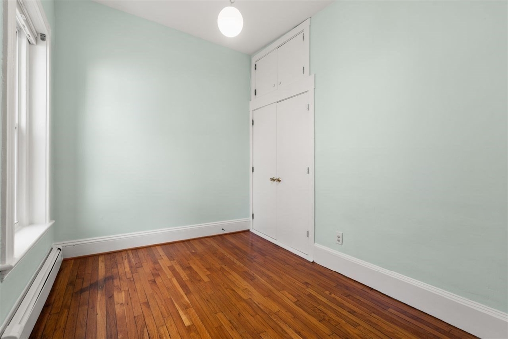 96 Brook Street, Unit 3 Brookline, MA 02445 - Photo 14 of 32 a view of empty room with wooden floor