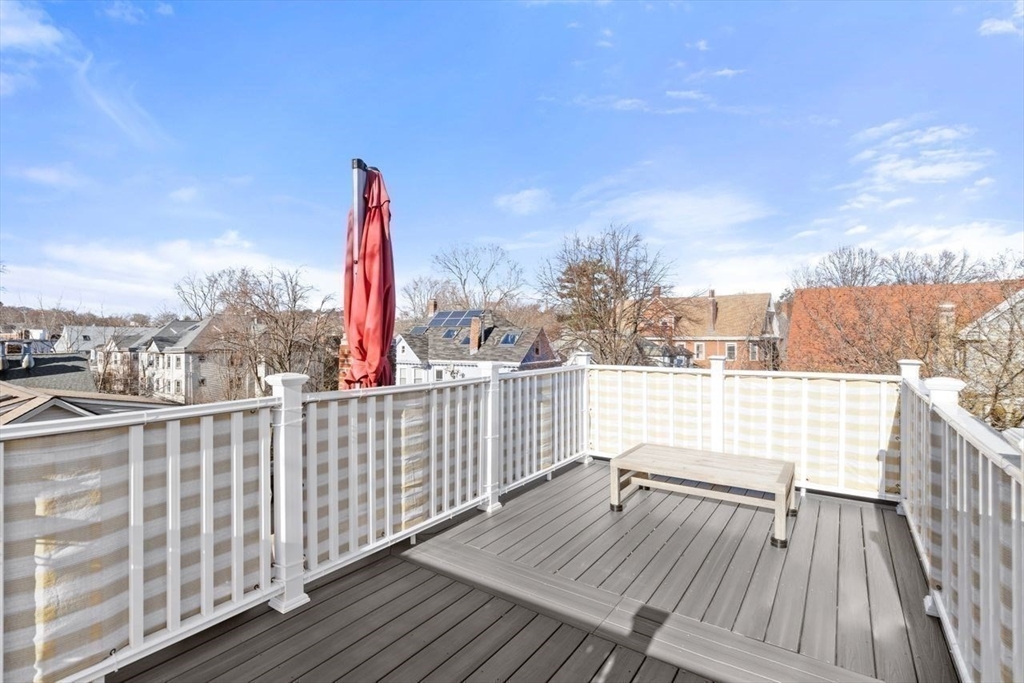 96 Brook Street, Unit 3 Brookline, MA 02445 - Photo 18 of 32 a view of balcony with wooden floor and fence