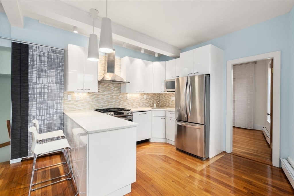 96 Brook Street, Unit 3 Brookline, MA 02445 - Photo 2 of 32 a kitchen with a stove top oven and refrigerator