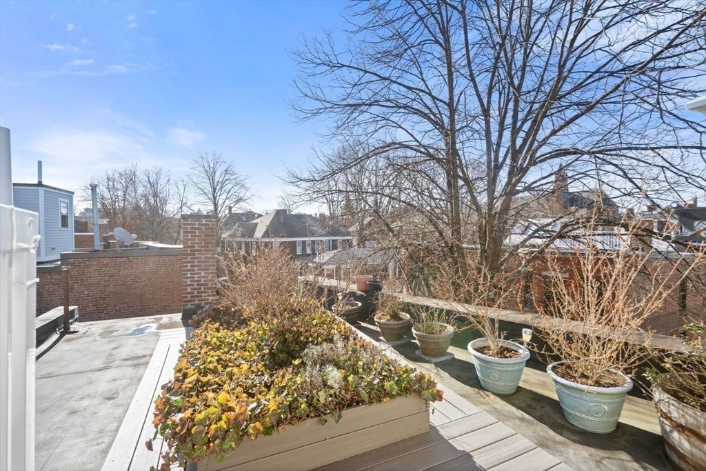 96 Brook Street, Unit 3 Brookline, MA 02445 - Photo 23 of 32 a view of a balcony with wooden floor and fence