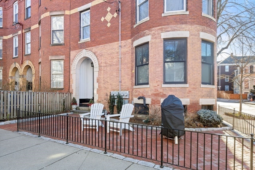 96 Brook Street, Unit 3 Brookline, MA 02445 - Photo 27 of 32 a view of a brick house with large windows