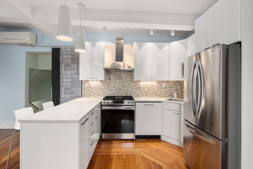 96 Brook Street, Unit 3 Brookline, MA 02445 - Photo 3 of 32 a kitchen with stainless steel appliances a refrigerator sink and stove