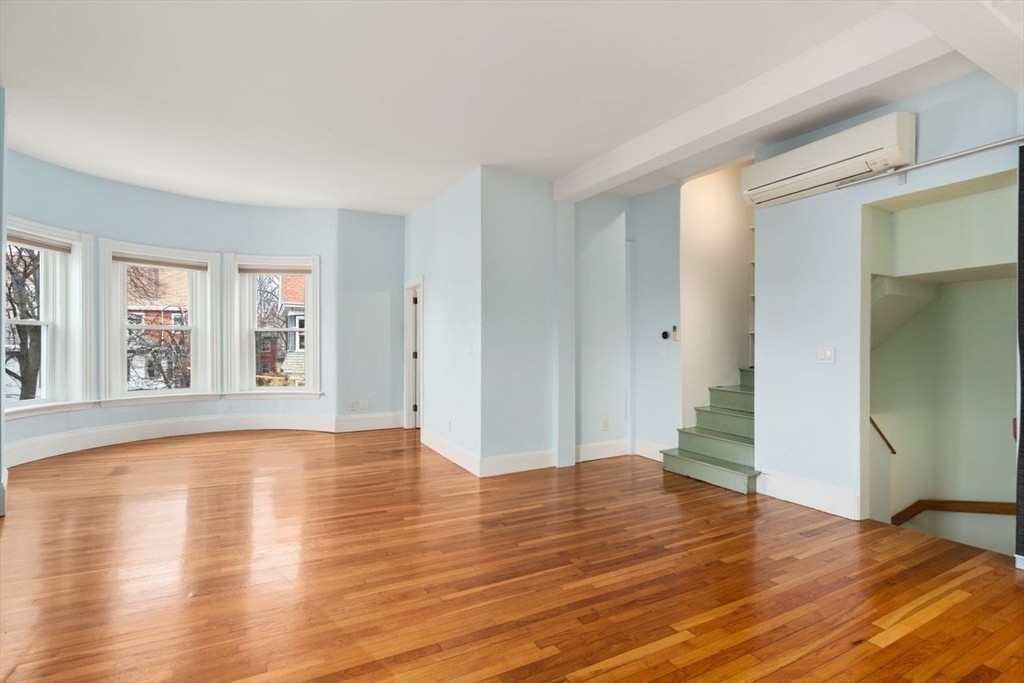 96 Brook Street, Unit 3 Brookline, MA 02445 - Photo 7 of 32 a view of empty room with wooden floor and fan
