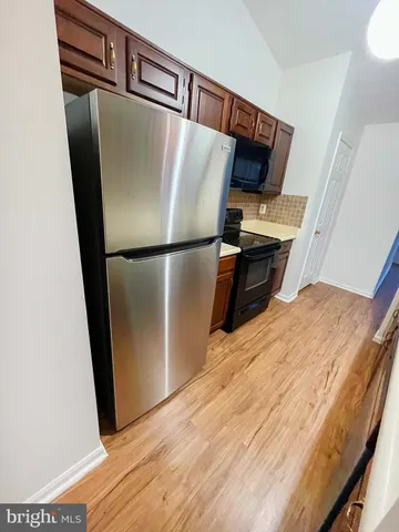 a view of a living room with wooden floor and staircase