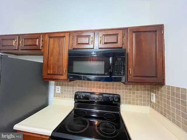 a stove top oven sitting inside of a kitchen