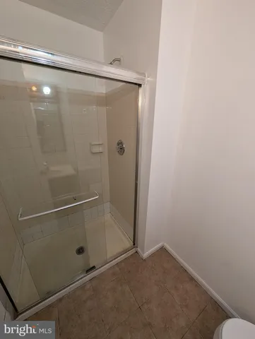 a bathroom with a glass shower door