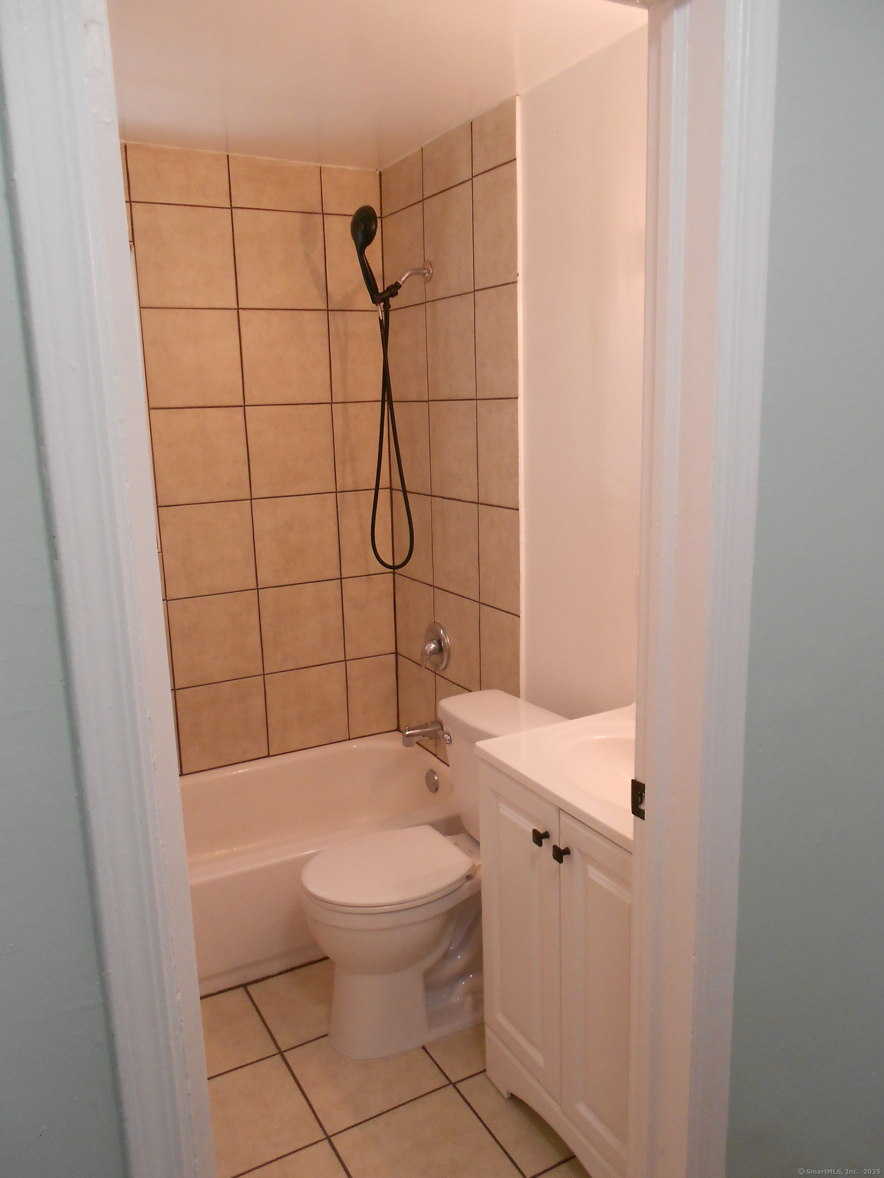 18 Bridge Street, Unit 1O Naugatuck, CT 06770 - Photo 2 of 11 a white toilet sitting next to a bathroom sink