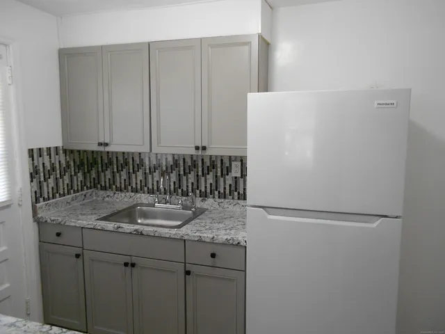 a bathroom with a granite countertop sink and mirror