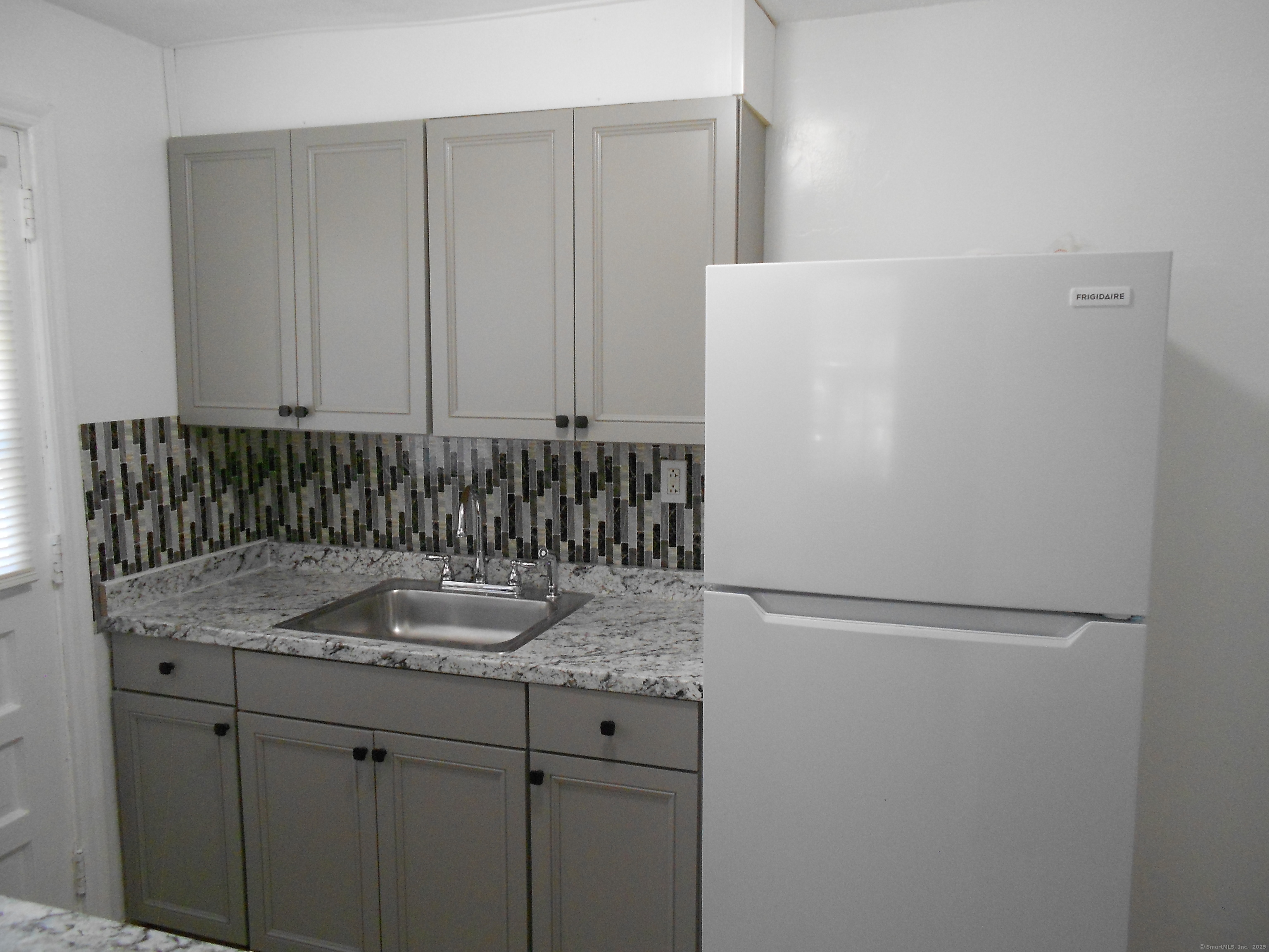 18 Bridge Street, Unit 1O Naugatuck, CT 06770 - Photo 6 of 11 a bathroom with a granite countertop sink and mirror
