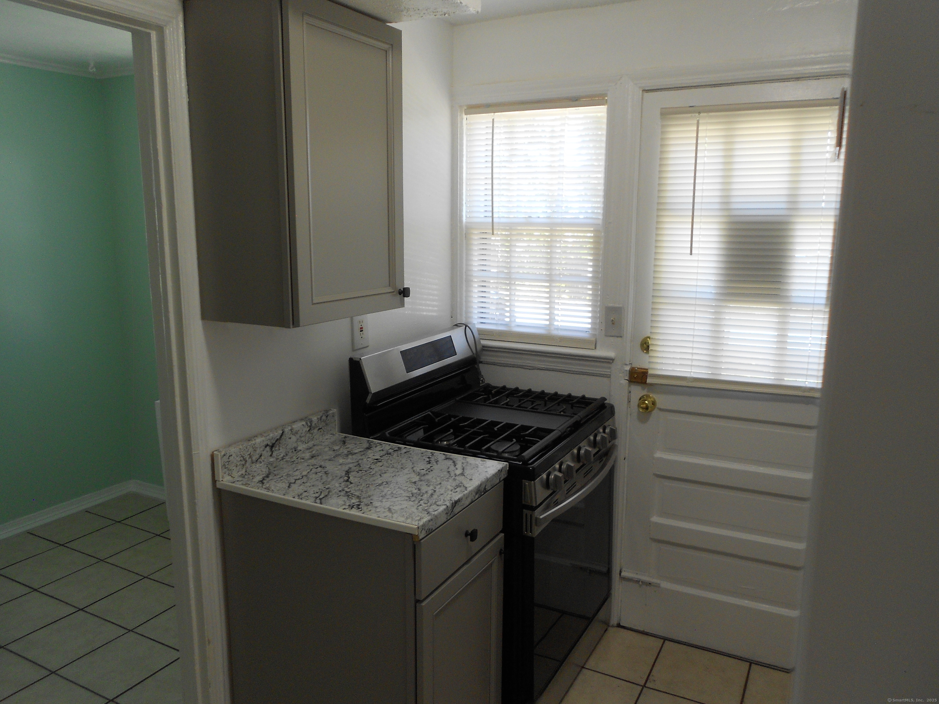 18 Bridge Street, Unit 1O Naugatuck, CT 06770 - Photo 7 of 11 a kitchen with a stove and a cabinet