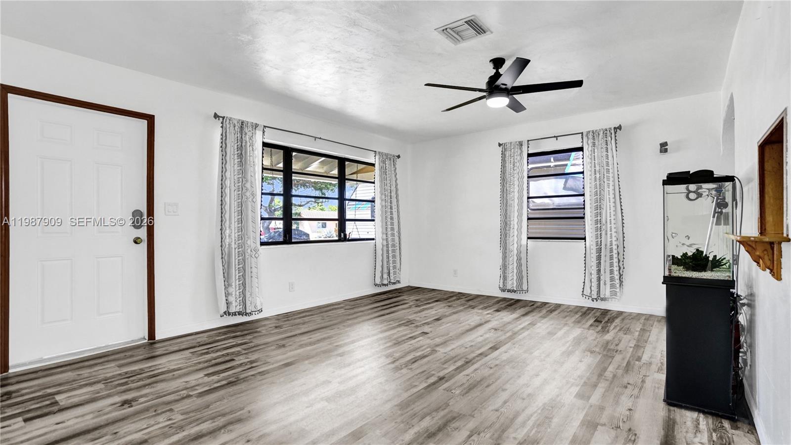 1007 North 31st Road Hollywood, FL 33021 - Photo 11 of 54 wooden floor in an empty room with a window