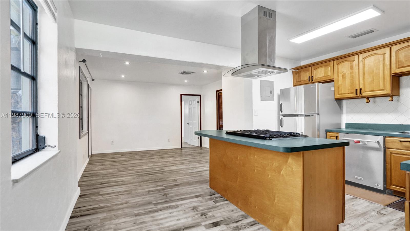 1007 North 31st Road Hollywood, FL 33021 - Photo 14 of 54 a kitchen with stainless steel appliances granite countertop a stove and a refrigerator