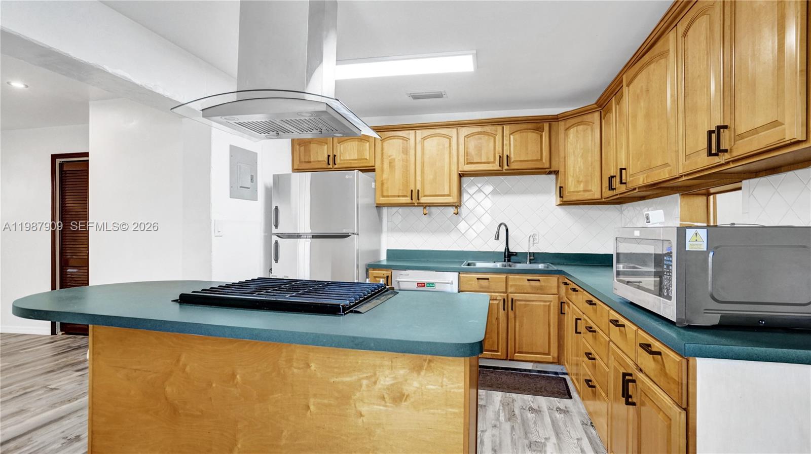 1007 North 31st Road Hollywood, FL 33021 - Photo 15 of 54 a kitchen with stainless steel appliances granite countertop a sink stove and cabinets