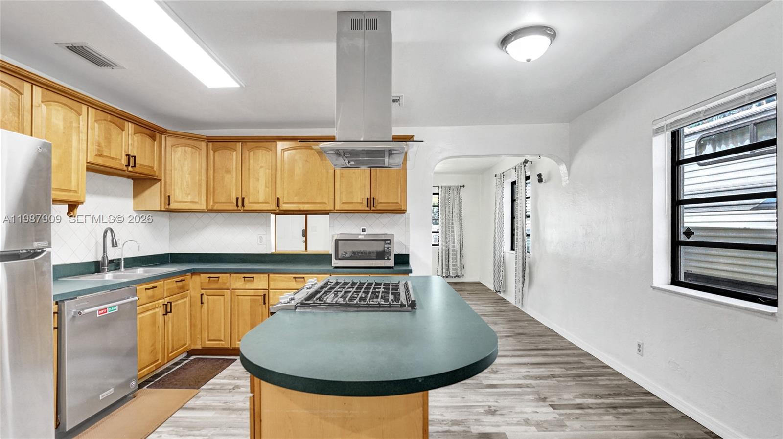 1007 North 31st Road Hollywood, FL 33021 - Photo 18 of 54 a kitchen with sink a refrigerator and cabinets