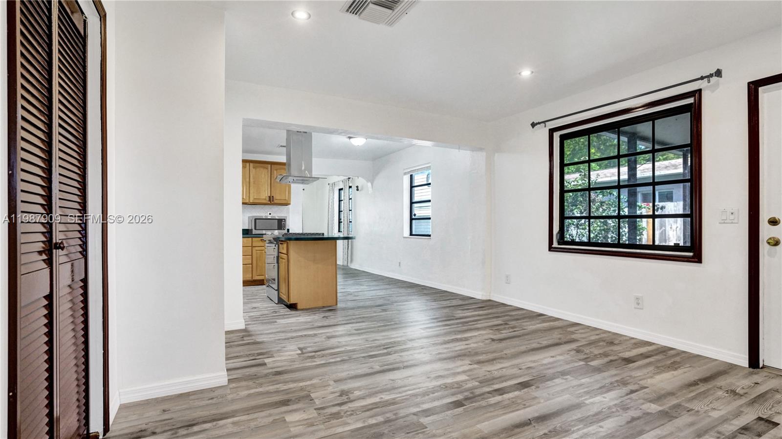 1007 North 31st Road Hollywood, FL 33021 - Photo 21 of 54 an empty room with wooden floor and windows