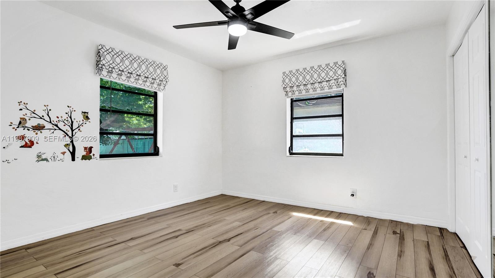 1007 North 31st Road Hollywood, FL 33021 - Photo 29 of 54 wooden floor in an empty room with a window