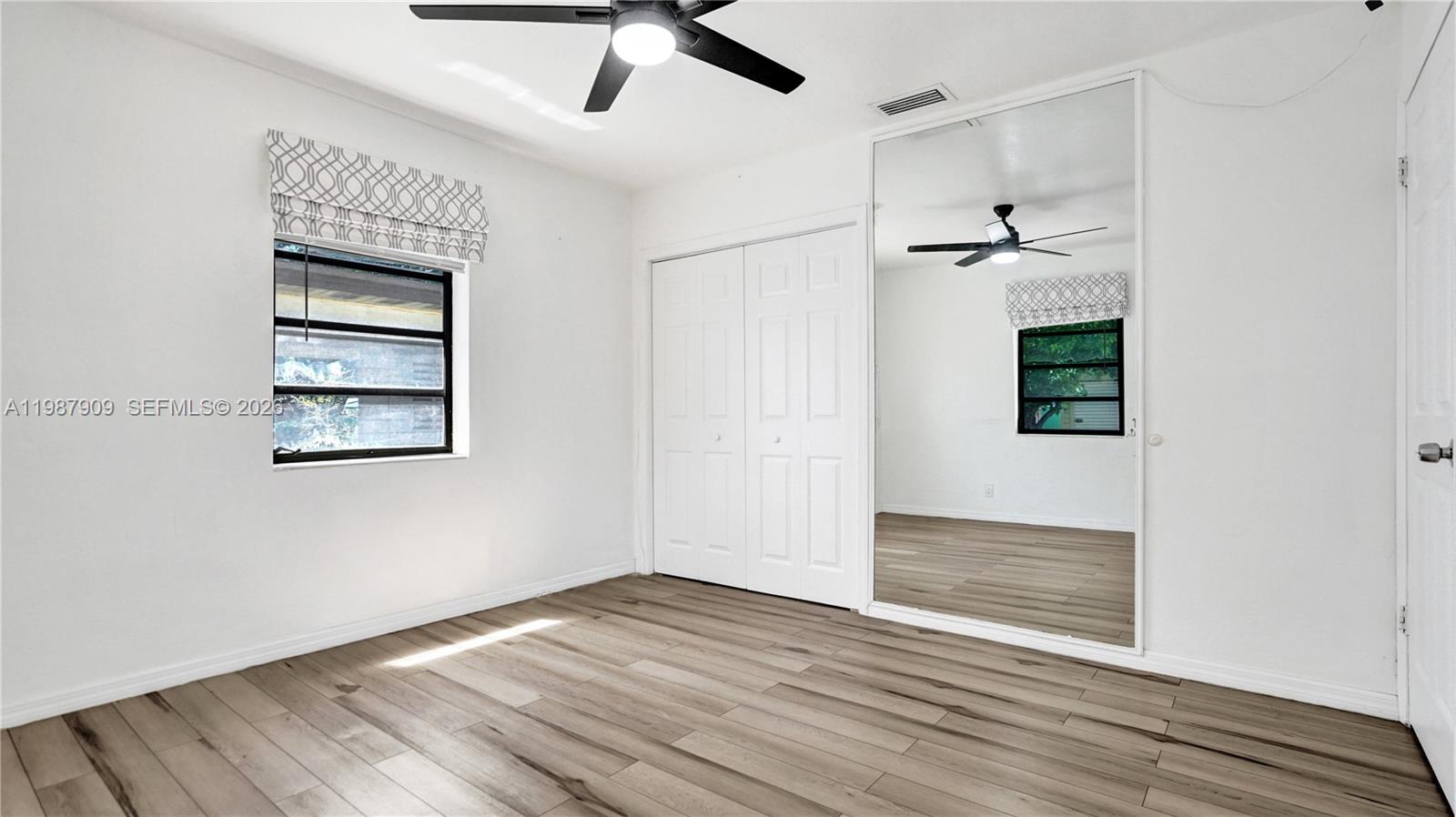 1007 North 31st Road Hollywood, FL 33021 - Photo 32 of 54 a view of an empty room with a window and wooden floor