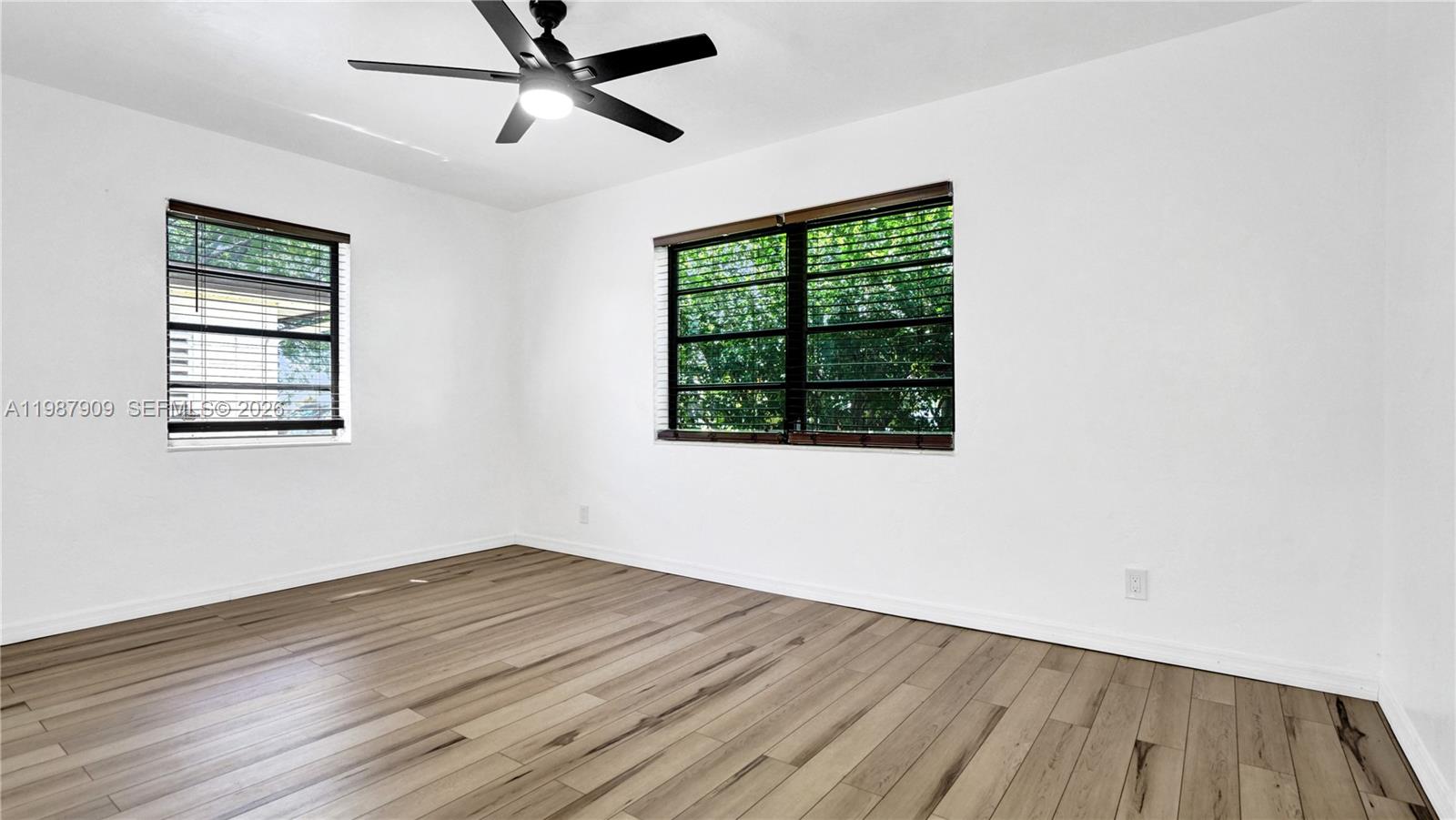 1007 North 31st Road Hollywood, FL 33021 - Photo 36 of 54 a view of empty room with wooden floor and fan