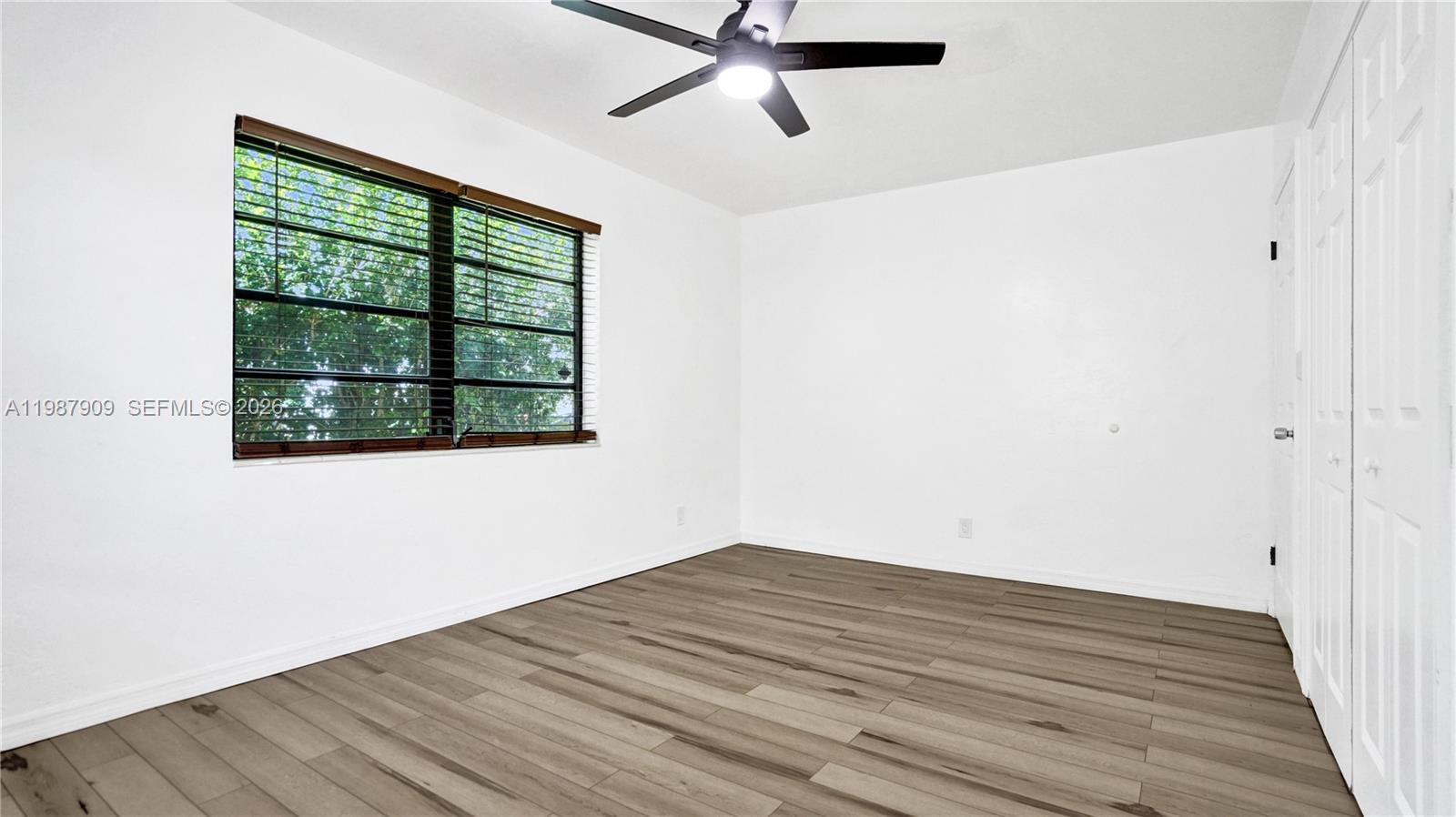 1007 North 31st Road Hollywood, FL 33021 - Photo 39 of 54 a view of an empty room with wooden floor and a window