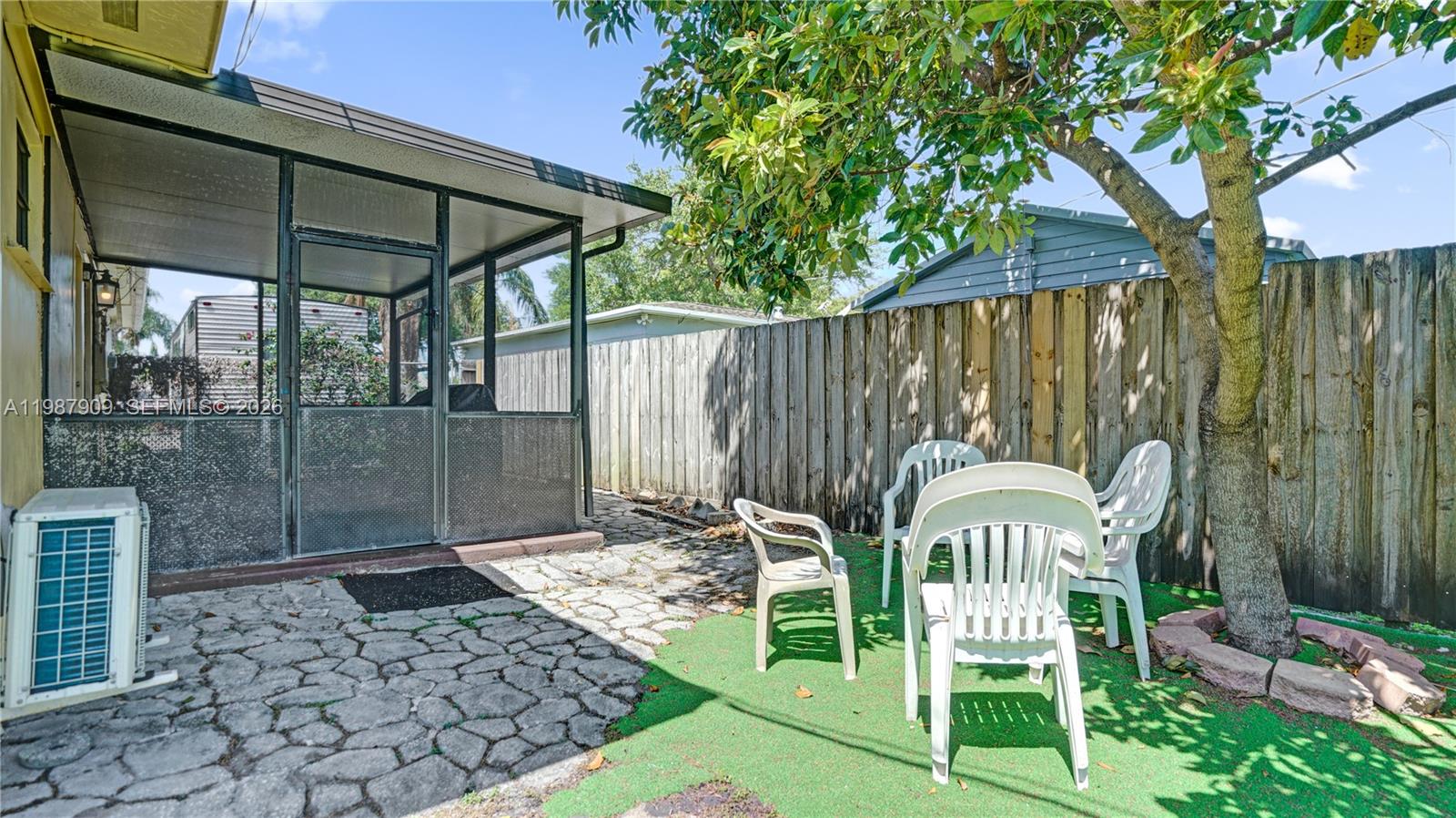 1007 North 31st Road Hollywood, FL 33021 - Photo 44 of 54 a view of a chair and table in backyard of the house
