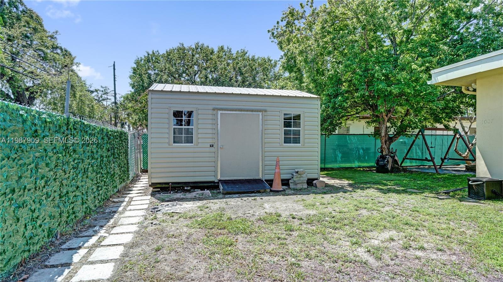 1007 North 31st Road Hollywood, FL 33021 - Photo 46 of 54 a view of backyard with potted plants and large tree