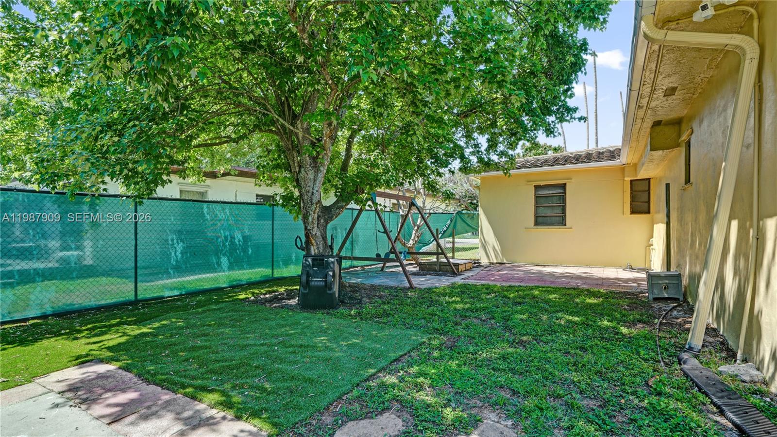 1007 North 31st Road Hollywood, FL 33021 - Photo 48 of 54 a view of a backyard with plants and a slide