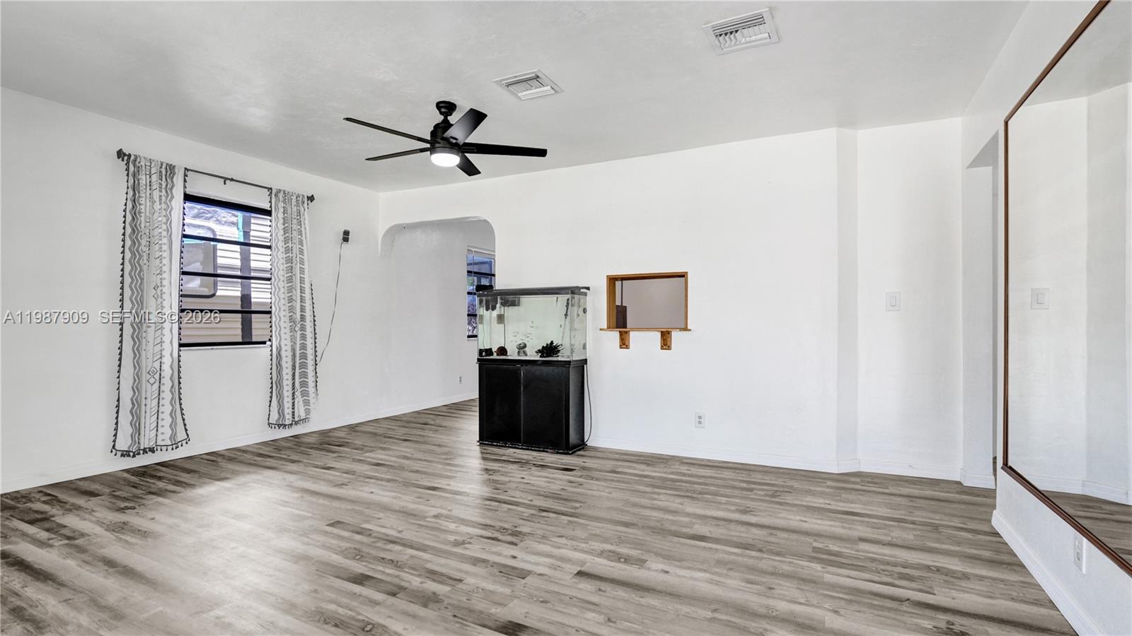 1007 North 31st Road Hollywood, FL 33021 - Photo 10 of 54 a view of a kitchen with wooden floor a ceiling fan and wooden floor