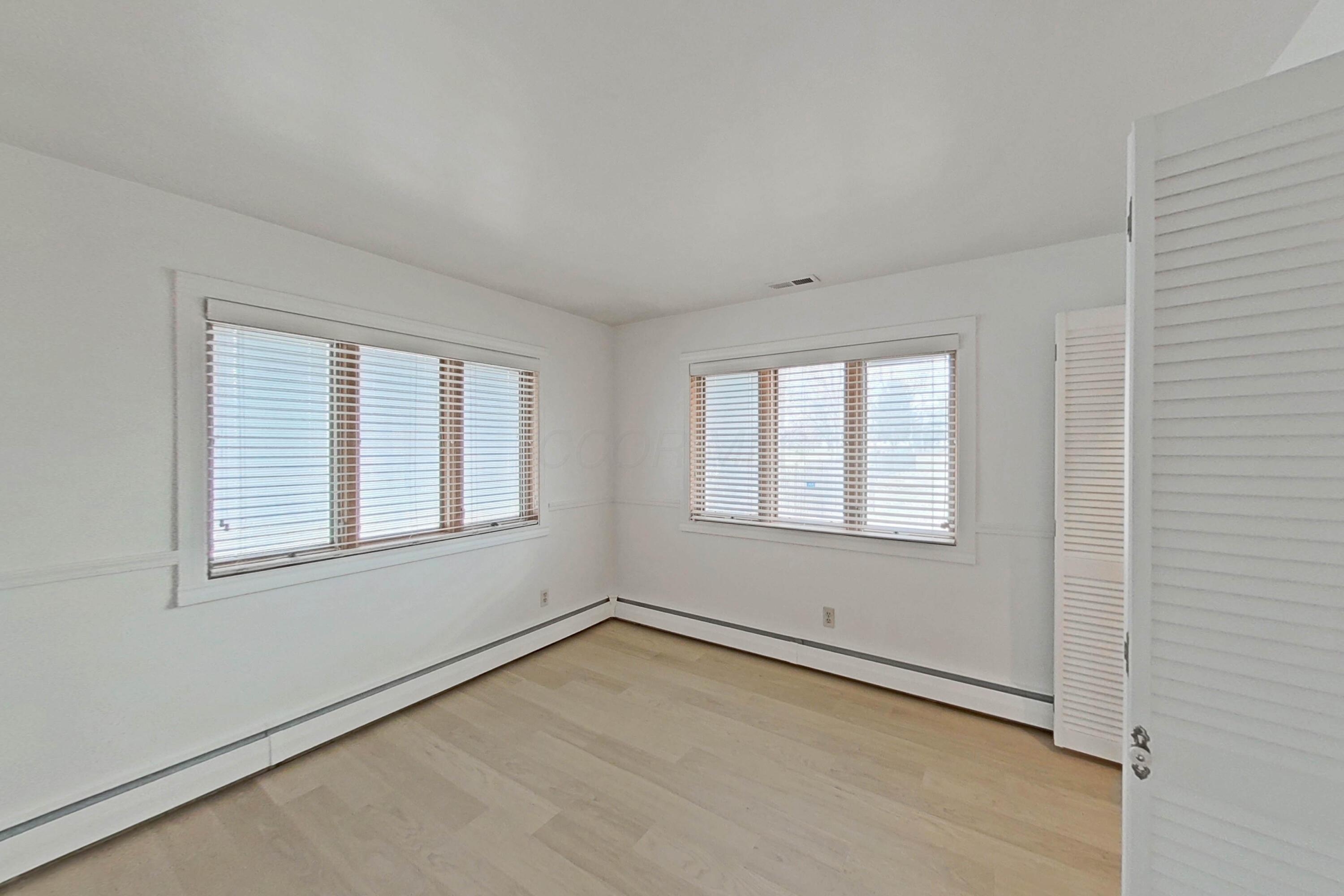 6982 Lee Road Westerville, OH 43081 - Photo 26 of 71 • New laminate flooring • White painted walls • Chair railing • Lighted closet with bi-fold doors • 2” blinds