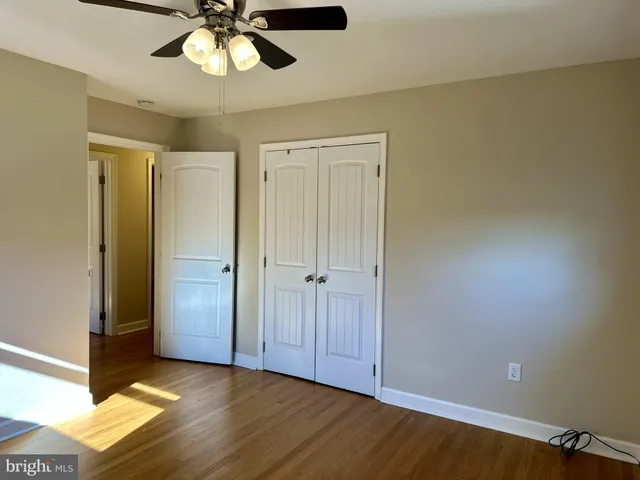 a view of a room with a ceiling fan