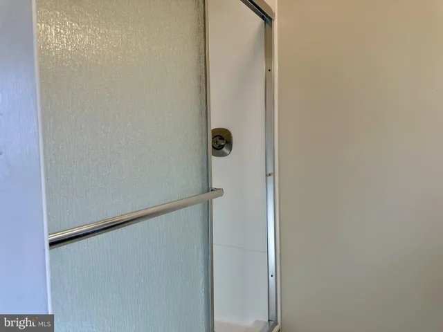 a view of a livingroom with wooden floor and a large window