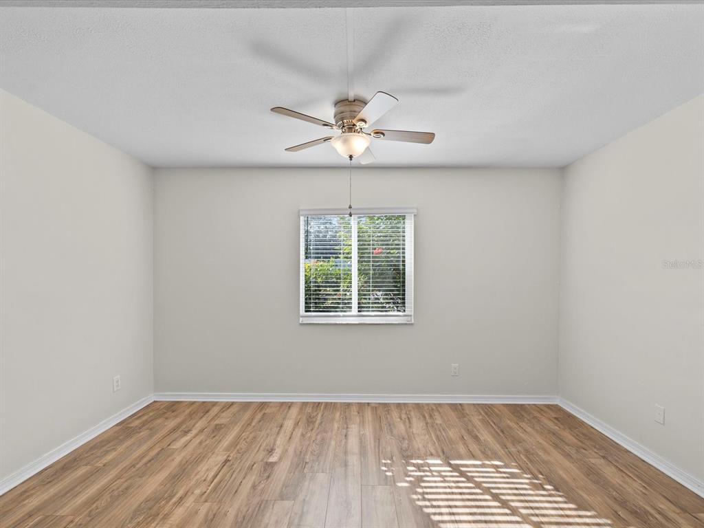 2737 Enterprise Road East, Unit 111 Clearwater, FL 33759 - Photo 12 of 28 an empty room with a window and a fan
